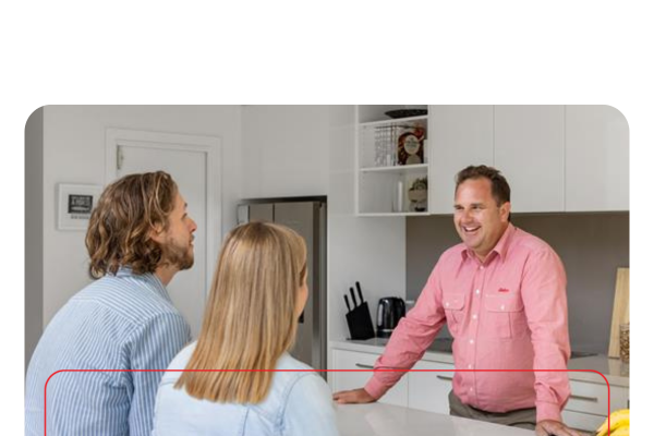 Staff member talking to clients over a kitchen bench.